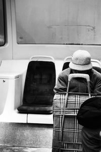 Person sitting with luggage in train