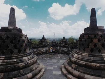 Ruins of temple against cloudy sky