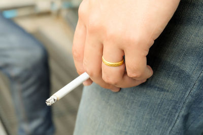 Low section of woman smoking cigarette