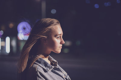 Woman looking away at night