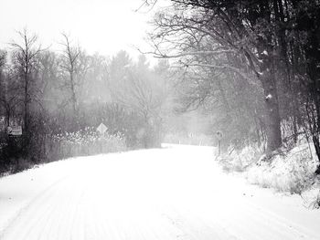 Road passing through snow covered landscape