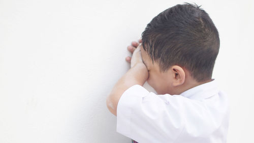 Portrait of boy against white background