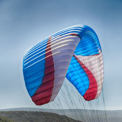 Low angle view of flag against blue sky