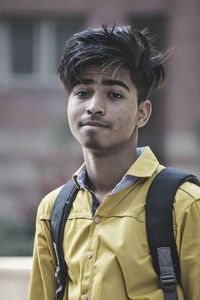 Portrait of young man standing outdoors