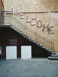 Wall of house with welcome sign by staircase