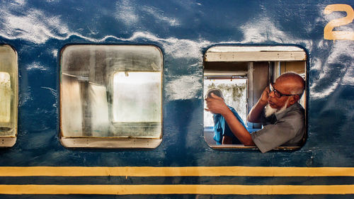 Men sitting by window