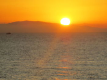 Scenic view of sea against romantic sky at sunset