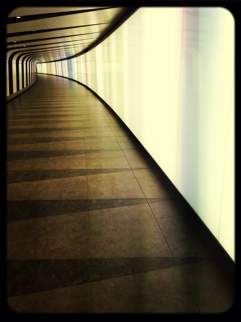 indoors, the way forward, diminishing perspective, architecture, empty, built structure, tiled floor, corridor, absence, vanishing point, transfer print, flooring, auto post production filter, railing, pattern, narrow, sunlight, steps, wall - building feature, walkway