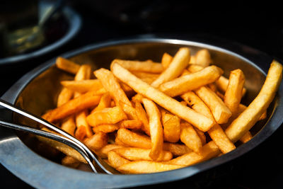 Close-up of french fries in plate on table