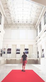 Rear view of woman walking in museum