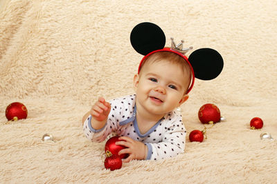 High angle view of girl by decoration on carpet