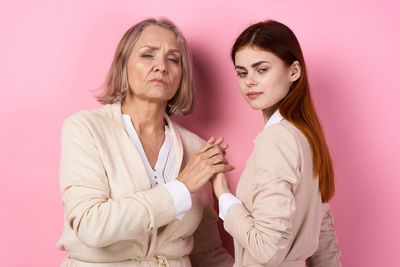 Portrait of woman with pink hair against gray background