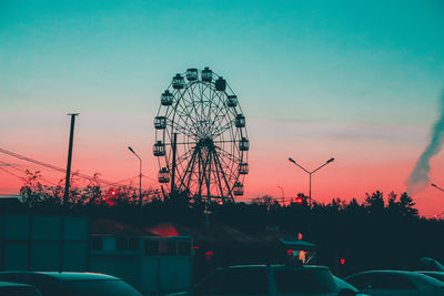 Silhouette ferris wheel against sky at sunset