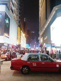 Illuminated city street at night