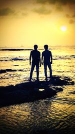 People on beach at sunset