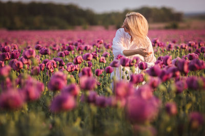 Smiling woman in tulip flower field