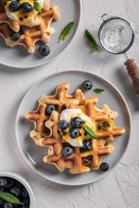 Breakfast with waffles with blueberries and syrup on a plates