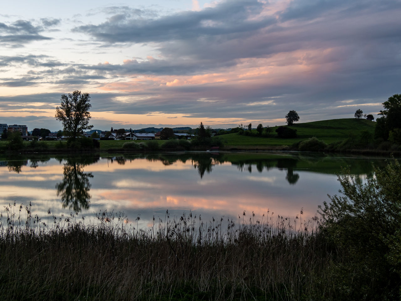 sky, cloud - sky, water, reflection, sunset, beauty in nature, tranquility, scenics - nature, tranquil scene, plant, nature, lake, non-urban scene, landscape, grass, idyllic, environment, no people, outdoors