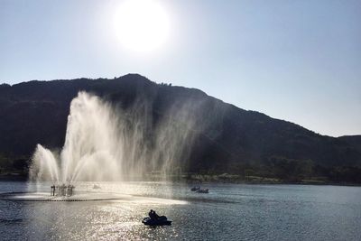 Scenic view of waterfall against sky