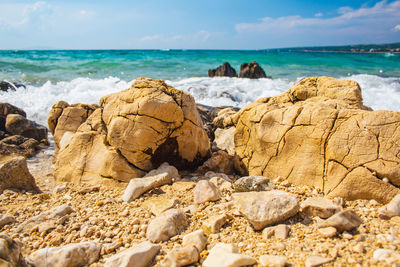 Rocks on beach against sky