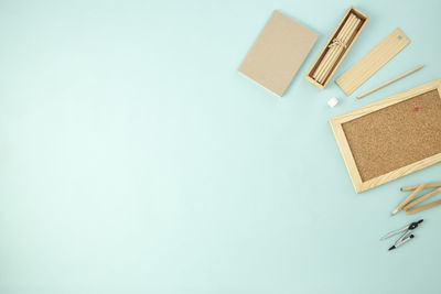 High angle view of colored pencils on table against blue background