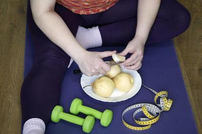 High angle view of woman preparing food on table at home