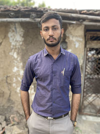 Portrait of young man standing outdoors