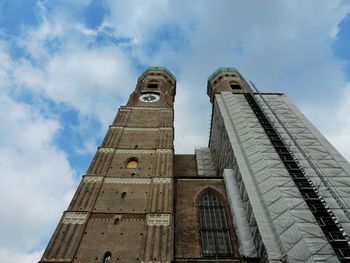 Low angle view of tower against cloudy sky