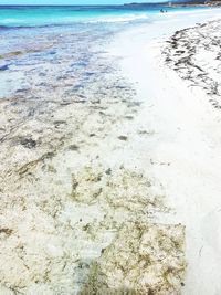 Close-up of sand on beach against sky