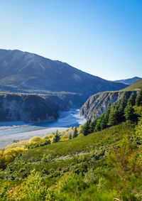 Scenic view of mountains against clear blue sky