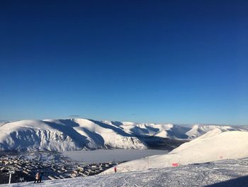 Scenic view of snowcapped mountains against clear blue sky