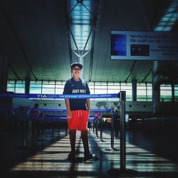 Full length portrait of man standing against illuminated building