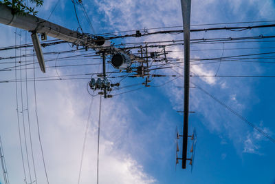 Low angle view of electricity pylon against sky