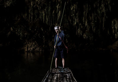 Portrait of mature man standing on boat at night