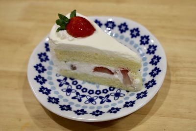 Close-up of strawberry cake in plate on table