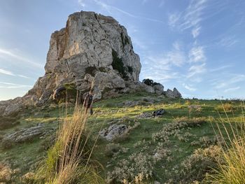 Rock formation on field against sky