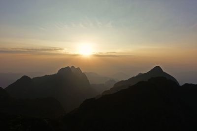 Scenic view of silhouette mountains against sky during sunset