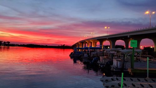 Bridge over river against sky during sunset