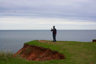 Rear view of man standing on beach
