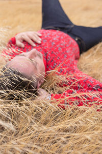 Low section of woman lying on field