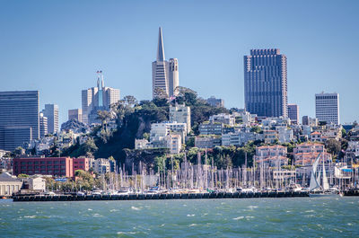 Modern buildings by city against sky