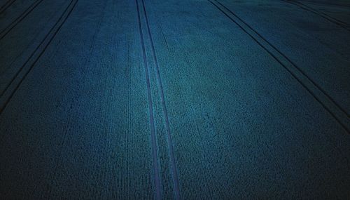 High angle view of empty road by railroad tracks