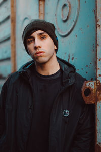 Portrait of young man wearing hat standing outdoors