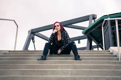 Portrait of woman sitting on staircase