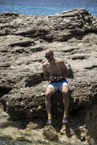 Full length of a man standing on rock