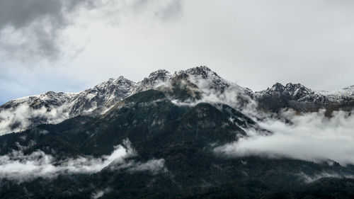 Scenic view of snow covered mountains against sky