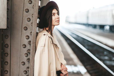 Portrait of young beautiful woman traveler who is waiting train