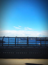 Bridge over sea against blue sky
