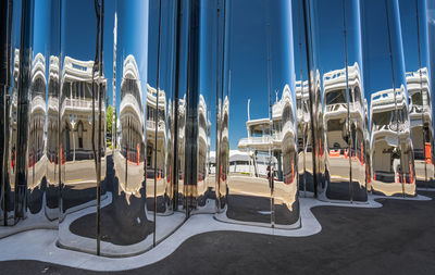 Panoramic view of city street against blue sky