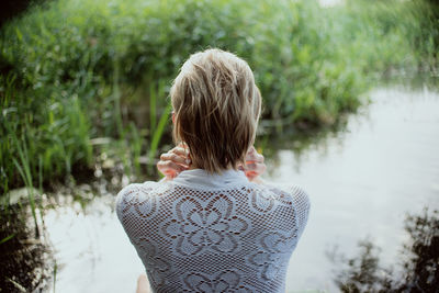 Rear view of woman standing in lake